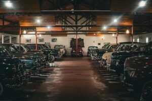 A collection of vintage cars showcased indoors in a classic car museum in PR, Brazil.