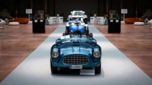 Showcase of classic vintage cars in a stylish indoor showroom setting.